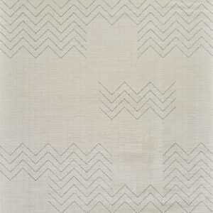 White fabric with zigzag embroidered patterns.