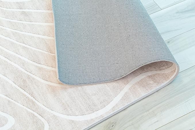 Beige geometric area rug on wooden floor