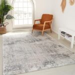 Modern living room with rug and armchair.