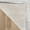 Corner of a rug on wood floor