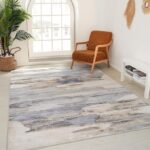 Modern living room with abstract rug and armchair.