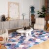 Modern living room with geometric rug and decor.