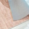 Beige rug corner flipped on hardwood floor