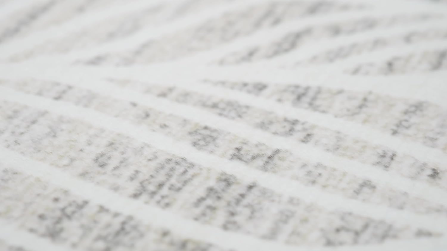 Close-up of textured light gray surface pattern.