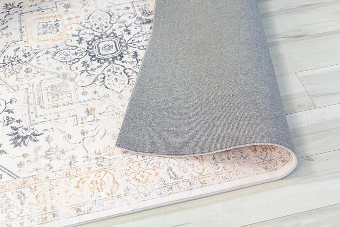 Decorative rug with intricate patterns on wooden floor.