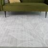 Gray rug with white leaf patterns.