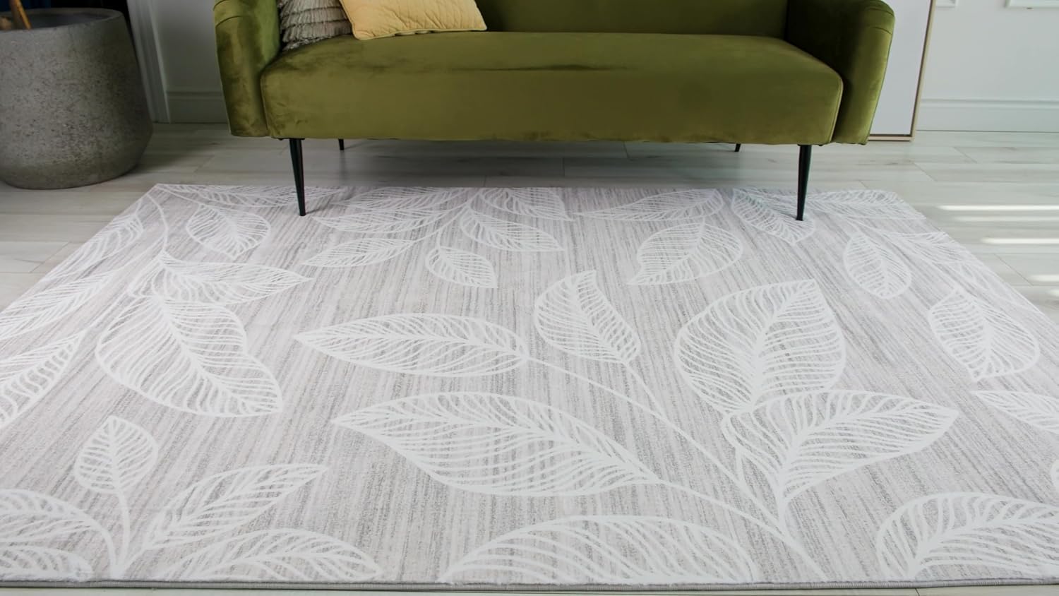 Gray rug with white leaf patterns.
