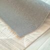 Corner of rug on wooden floor