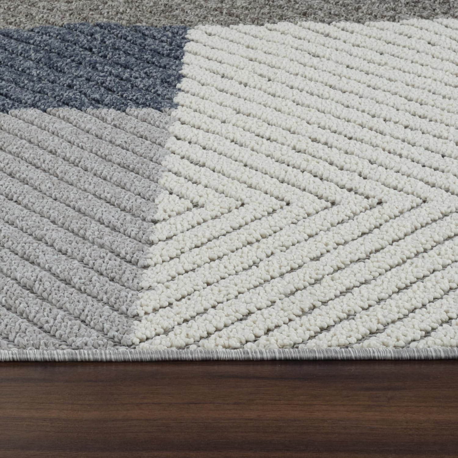 Chevron patterned carpet with gray, white colors