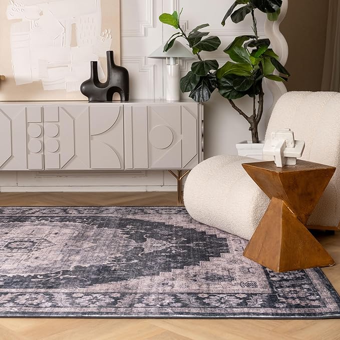 Modern living room with geometric decor and plants.
