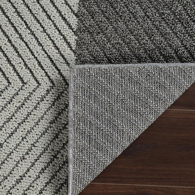 Gray chevron pattern rug on wooden floor.