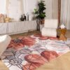 Modern living room with floral area rug and chair.