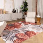 Modern living room with floral area rug and chair.