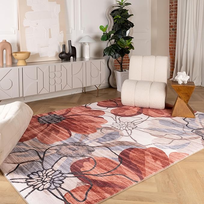 Modern living room with floral area rug and chair.