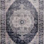Intricate black and gray patterned rug, vintage style.