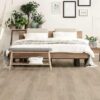 Minimalist bedroom with wooden floor and hammock.