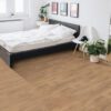 Modern bedroom with wooden floor and plants