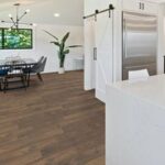 Modern kitchen with wood floor and dining area.