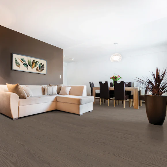 Modern living room with beige couch and dining area.