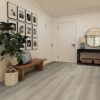 Modern hallway with framed photos and wooden bench.