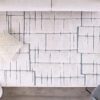 Modern geometric rug, neutral tones, cozy living room.
