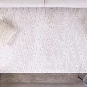 Textured white rug on wooden floor with pillows.