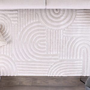 Modern geometric patterned beige rug on wooden floor.