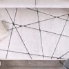 Modern white rug with black geometric lines.