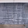 Gray geometric patterned rug on wooden floor