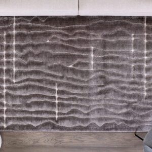 Gray textured rug on wooden floor.