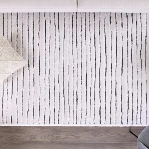 Modern striped rug with cozy pillows in living room.
