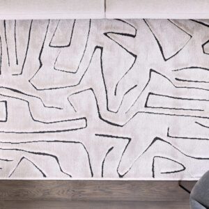 Abstract pattern rug on wooden floor.