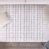 Modern living room rug with geometric pattern and pillows.