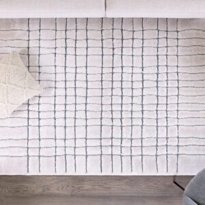 Modern living room rug with geometric pattern and pillows.