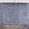Gray geometric rug on wooden floor