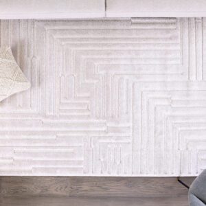 Modern beige rug with geometric pattern on hardwood floor.