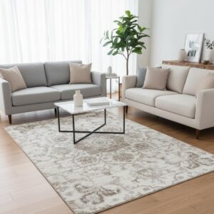 Modern living room with beige sofas and rug.