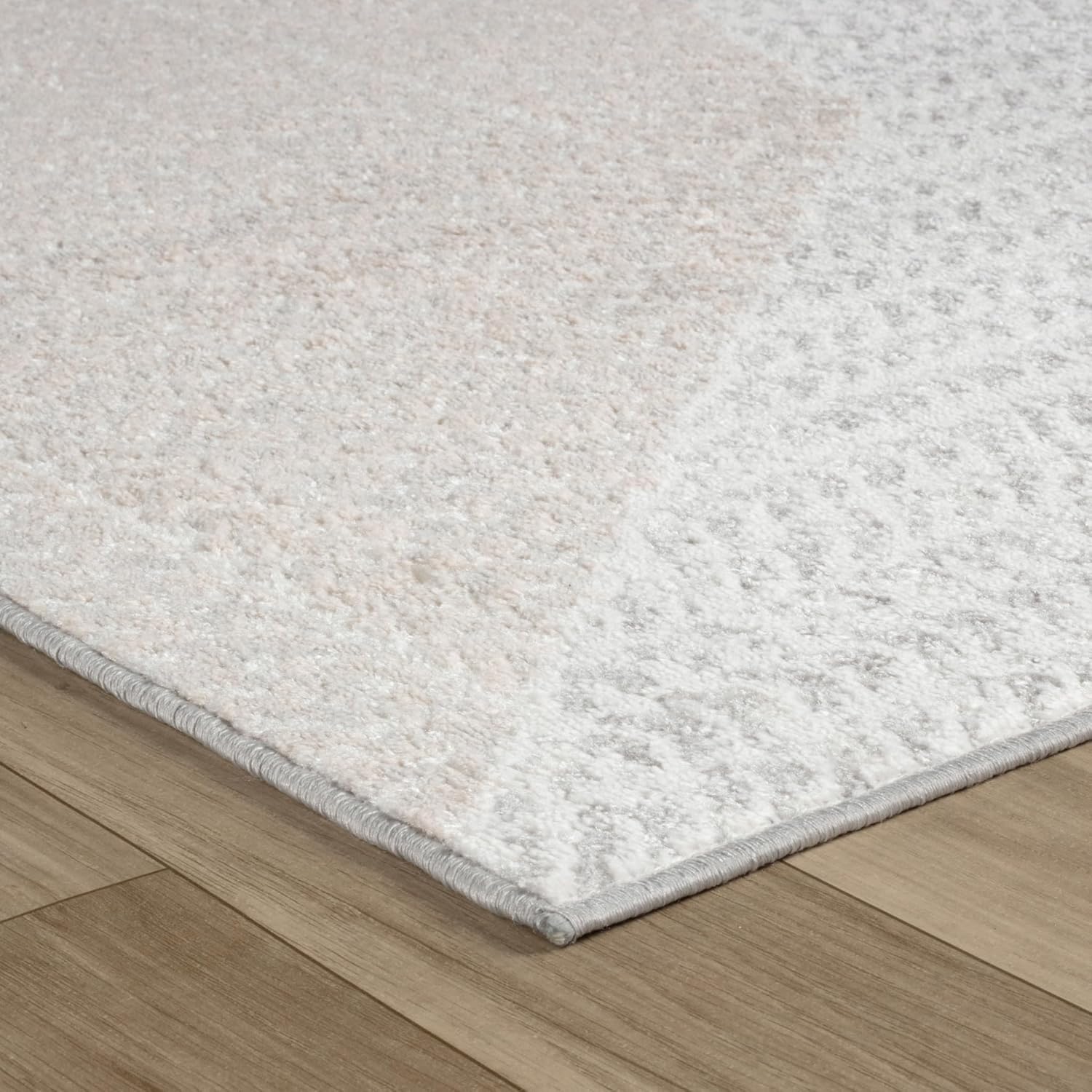 Textured white rug on wooden floor