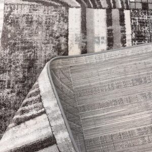 Gray patterned rug with corner lifted