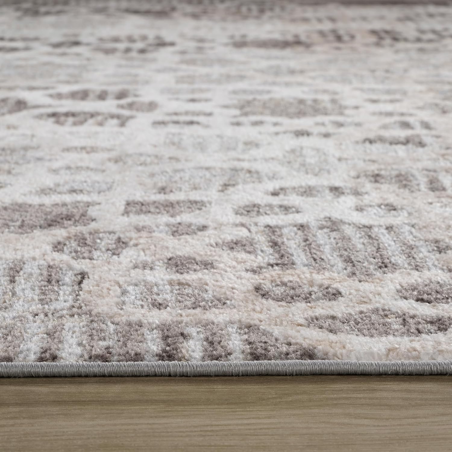 Beige and white geometric patterned area rug.