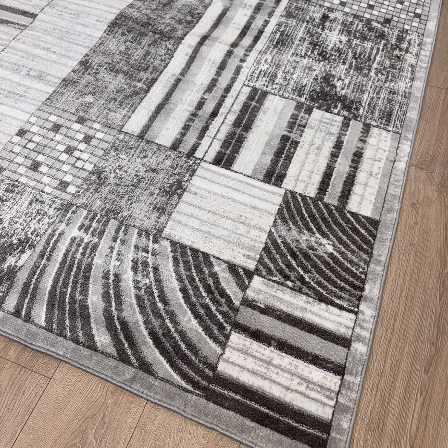 Gray geometric pattern rug on wooden floor