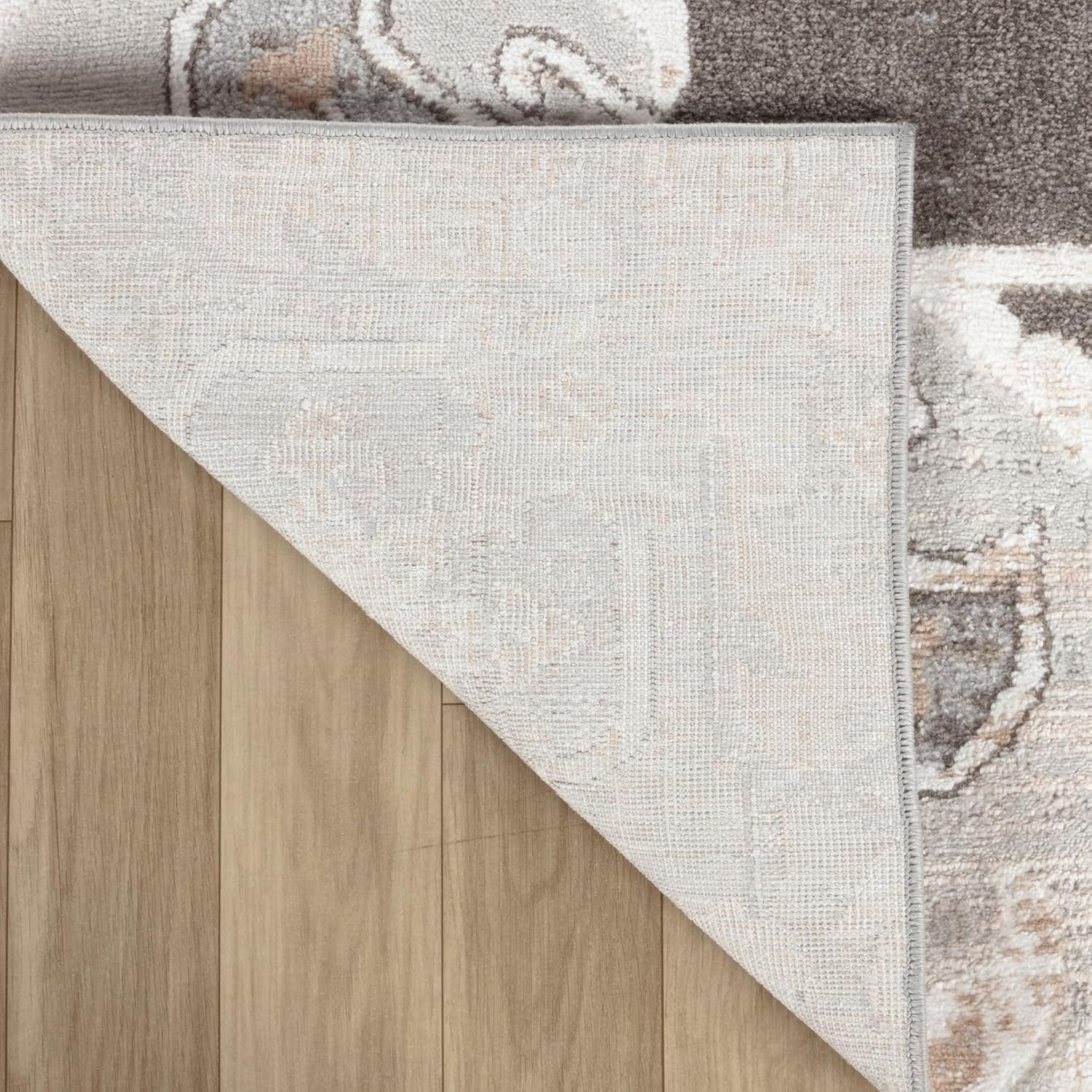 Reversible rug corner folded on wooden floor