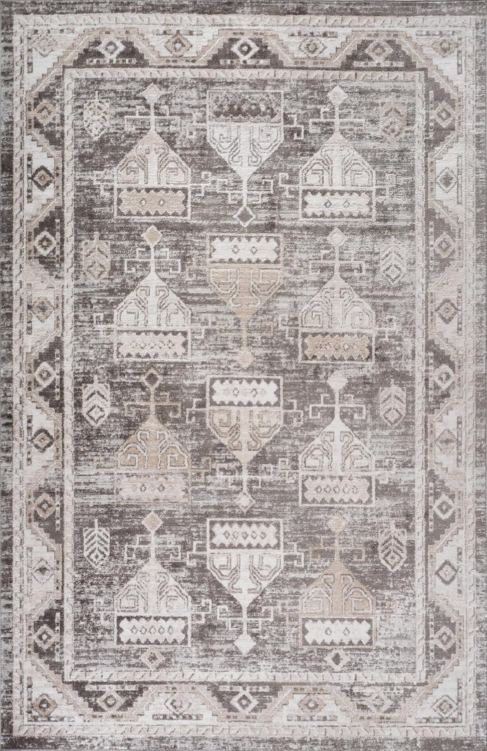 Patterned gray and white area rug with geometric design.